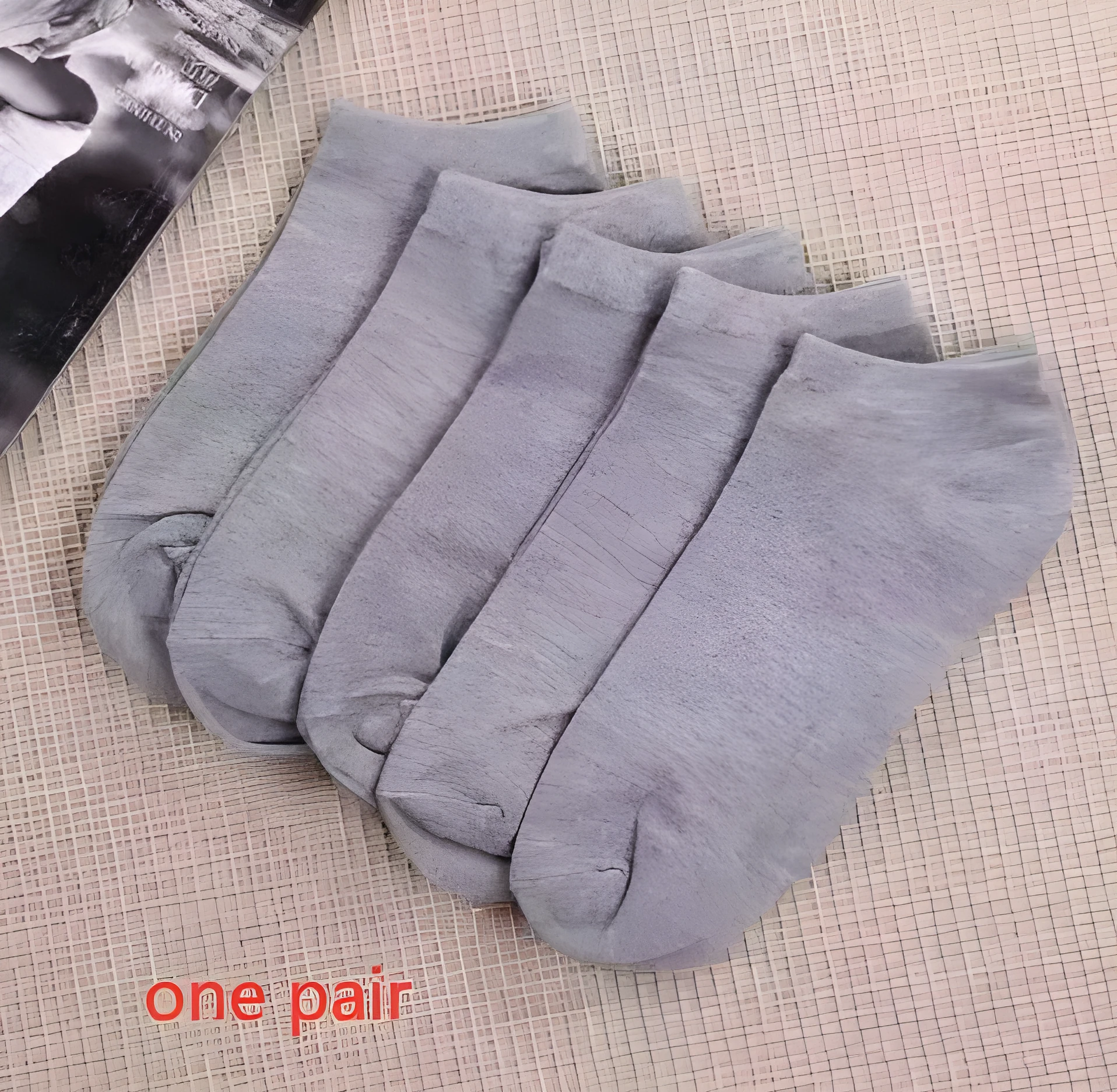 Black, white, and grey boat socks and medium tube socks from Degner in cotton blend fabric