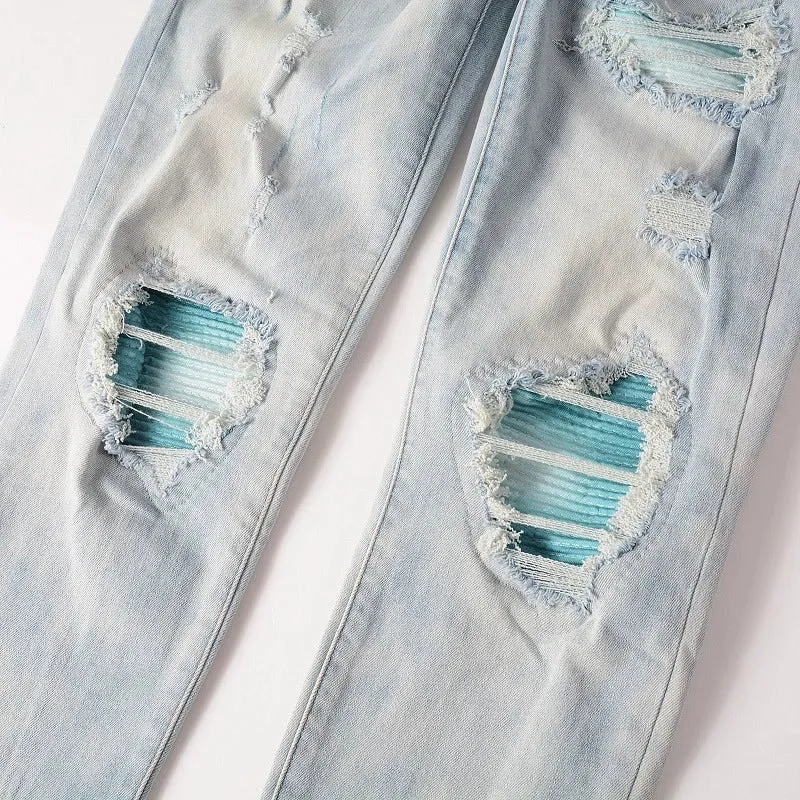 Men's light blue distressed slim fit jeans with five pocket patchwork, enzyme washed, side view