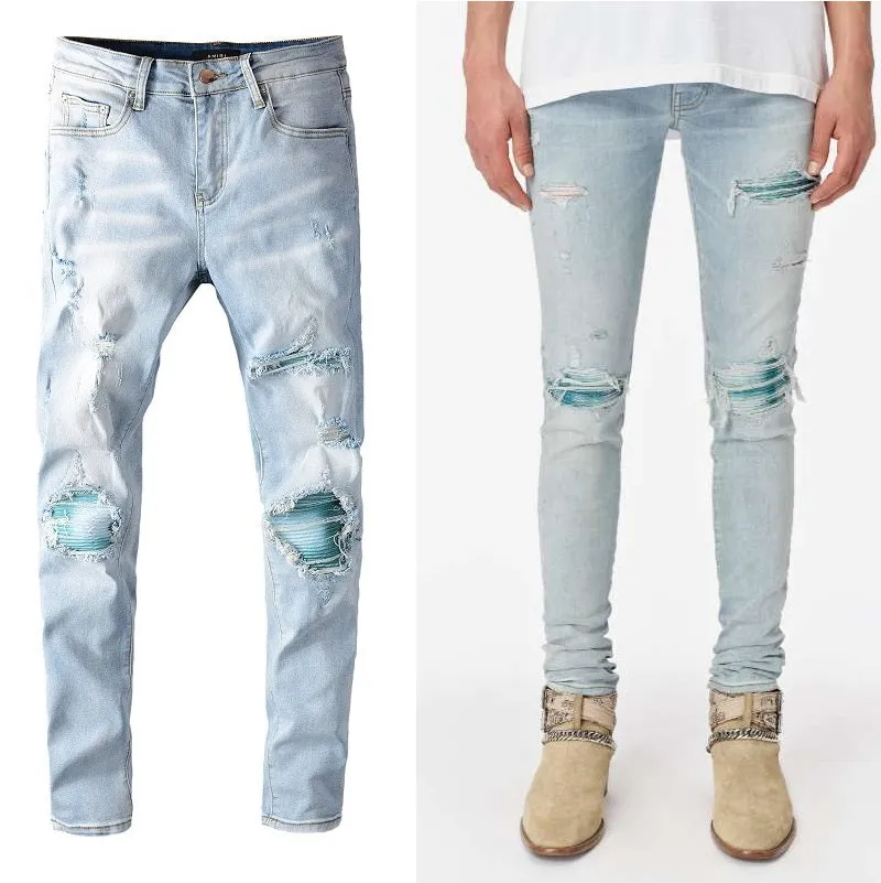 Men's light blue distressed slim fit jeans with five pocket patchwork, enzyme washed, side view