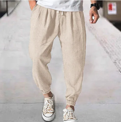 Man wearing loose light-coloured cotton trousers with elasticated ankle cuffs, showing front and side views.