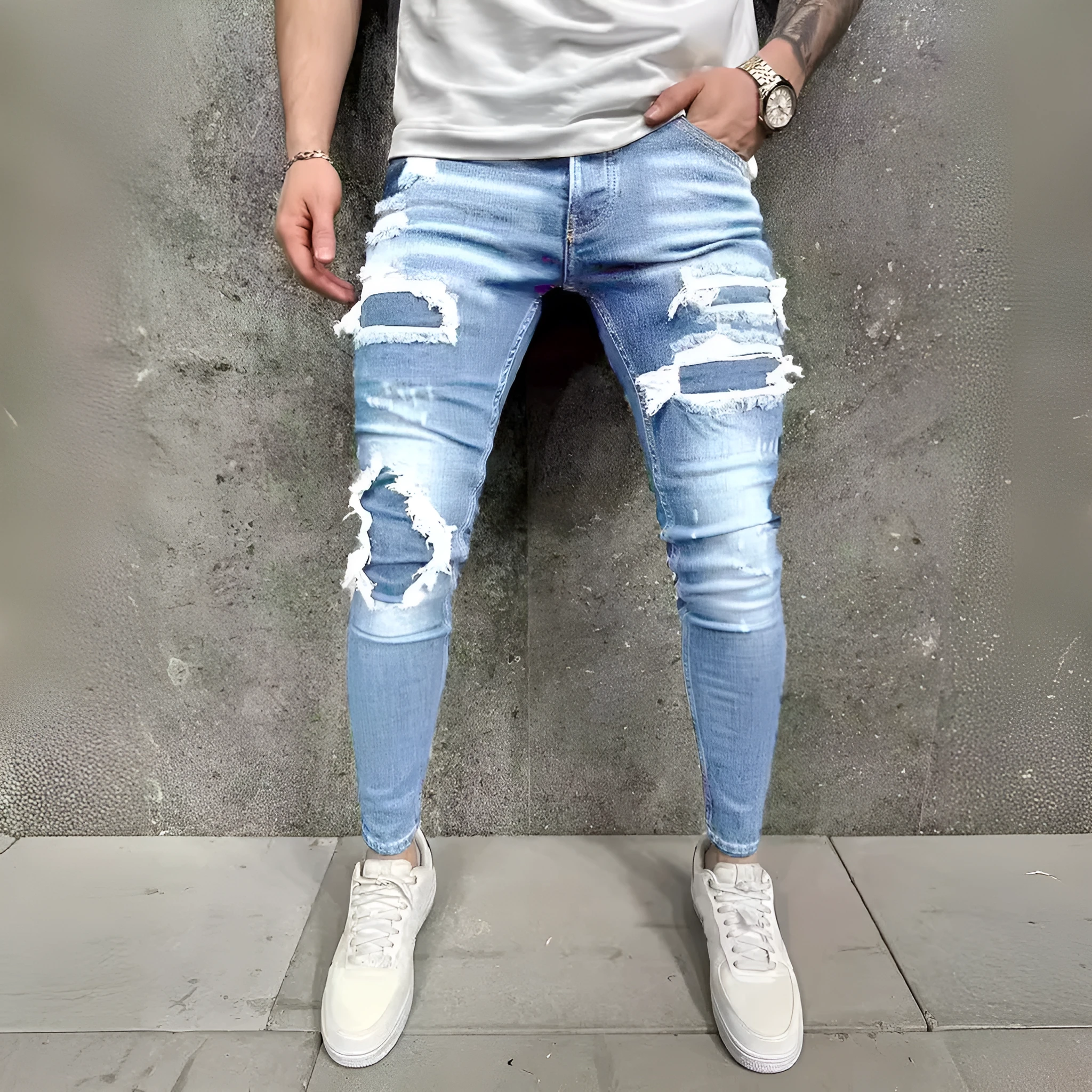 Men's denim jeans with worn-out patch detail in light blue, mid-waist tight fit British style