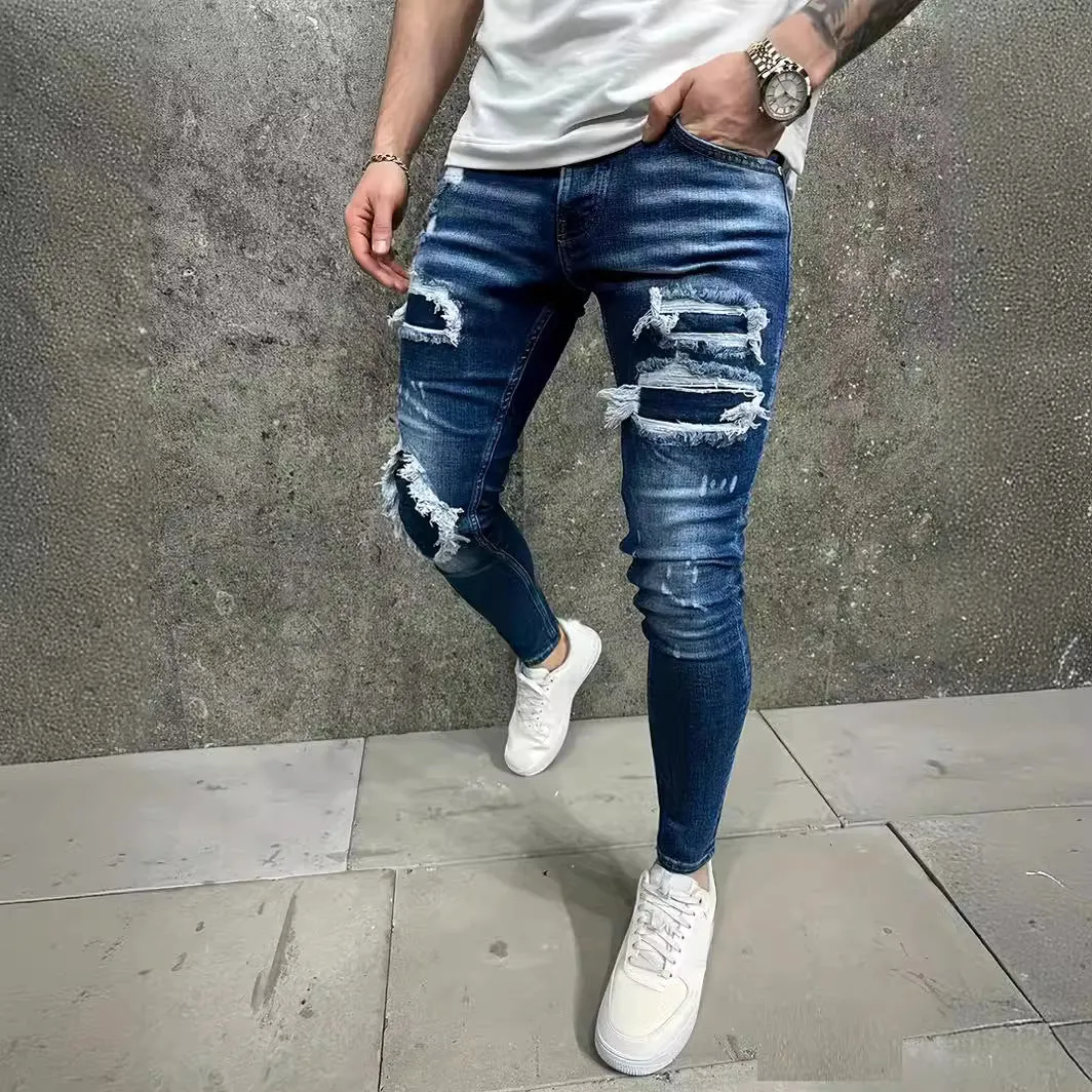 Men's denim jeans with worn-out patch detail in light blue, mid-waist tight fit British style