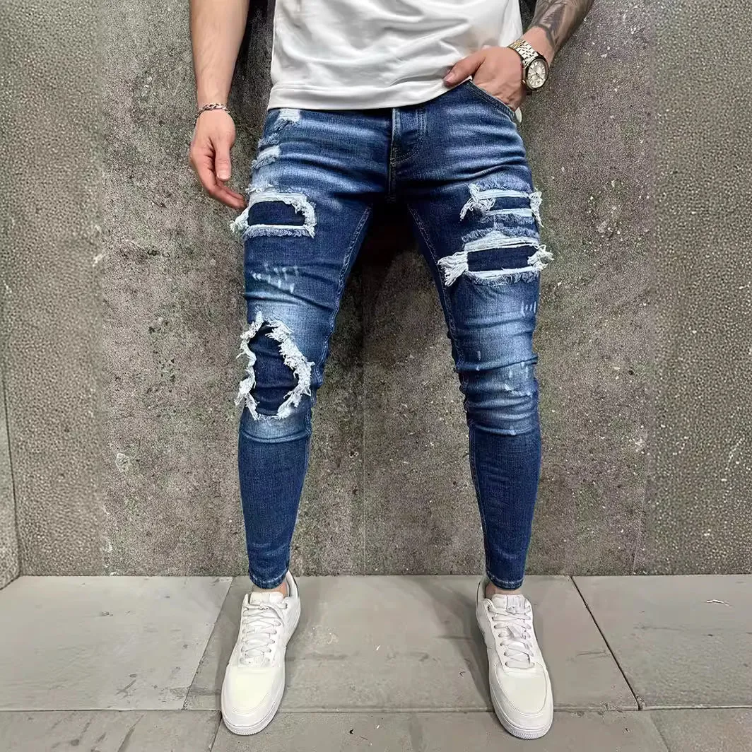 Men's denim jeans with worn-out patch detail in light blue, mid-waist tight fit British style