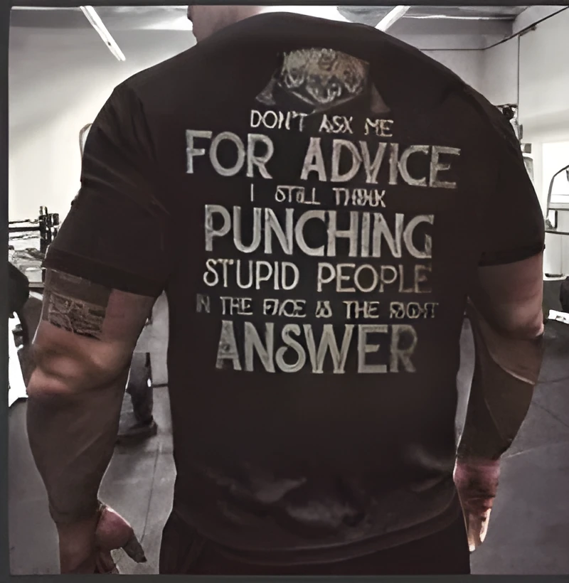 Mens black loose-fit polyester T-shirt with skull and slogan print on front, shown on model