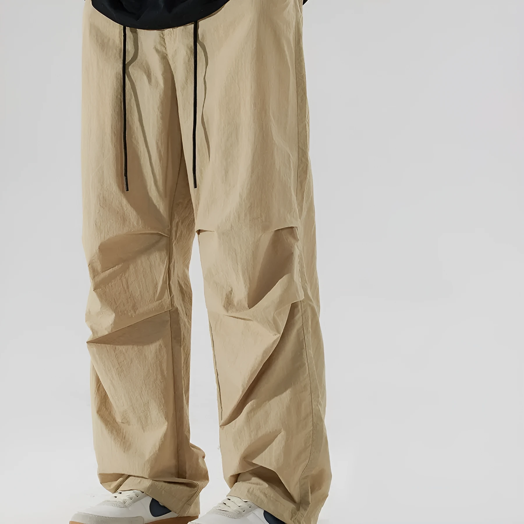 Men's loose straight-leg casual trousers in thin ice silk nylon fabric, shown in apricot colour.