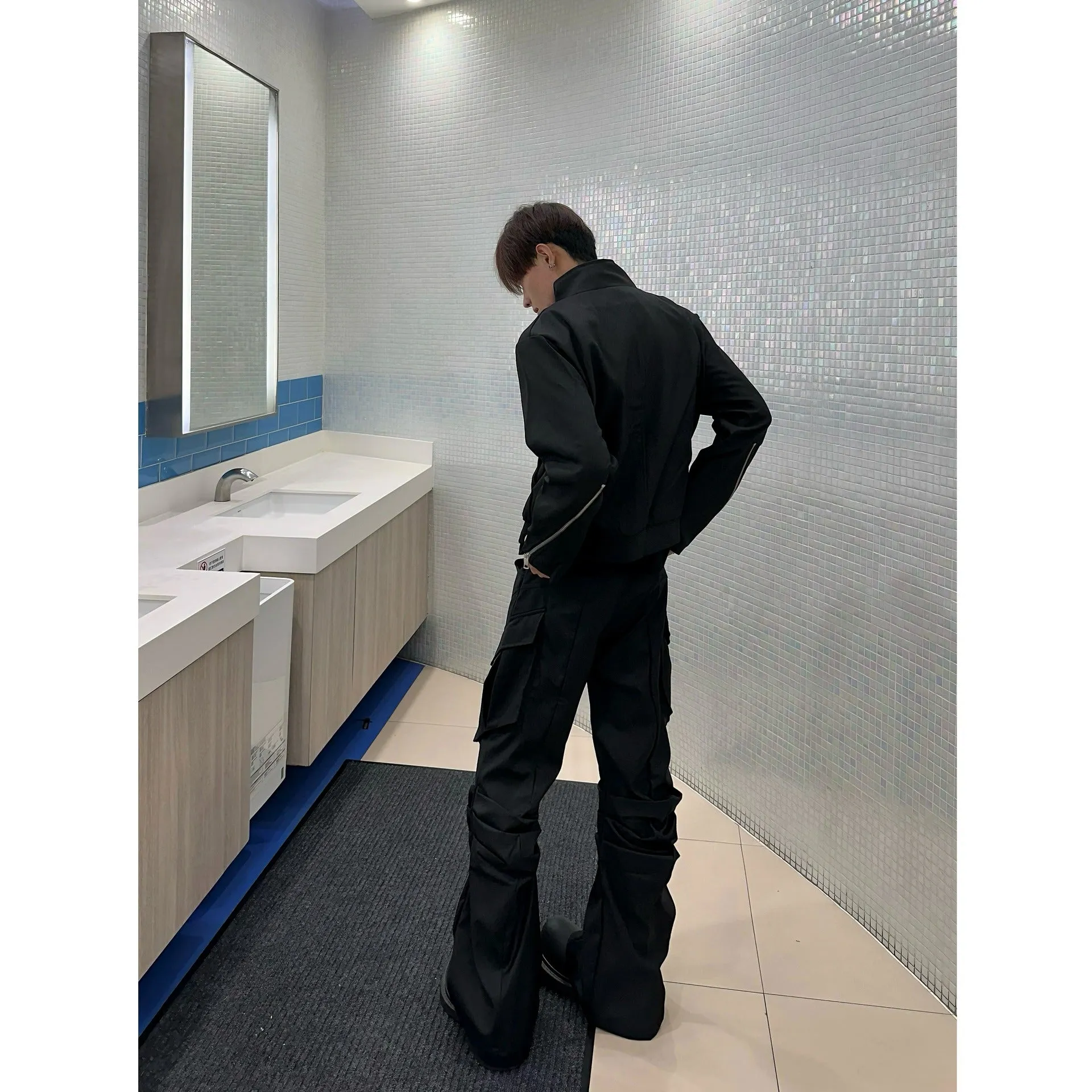 Men's black cargo trousers with large side pockets, straight-leg cut, on a plain background