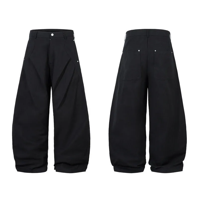 Black men's pleated casual trousers with a loose wide-leg fit on a hanger