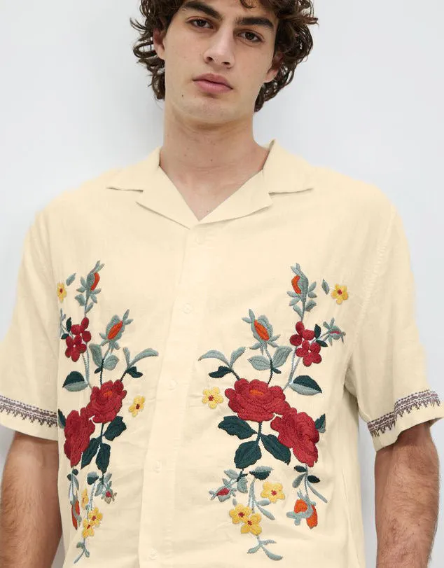 Apricot-coloured men's casual shirt with vintage floral print, short sleeves, and a cardigan-style lapel.