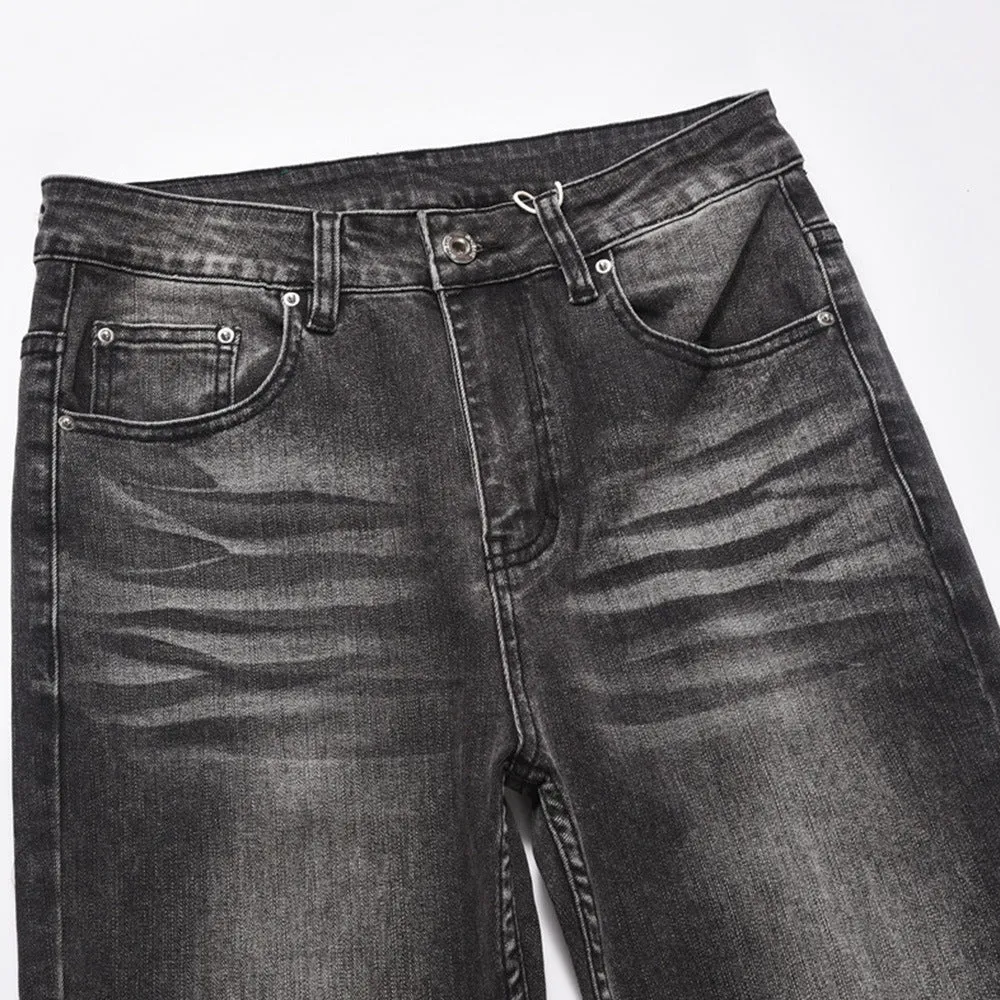 Men's black washed denim jeans on a flat surface showing full leg and pocket details