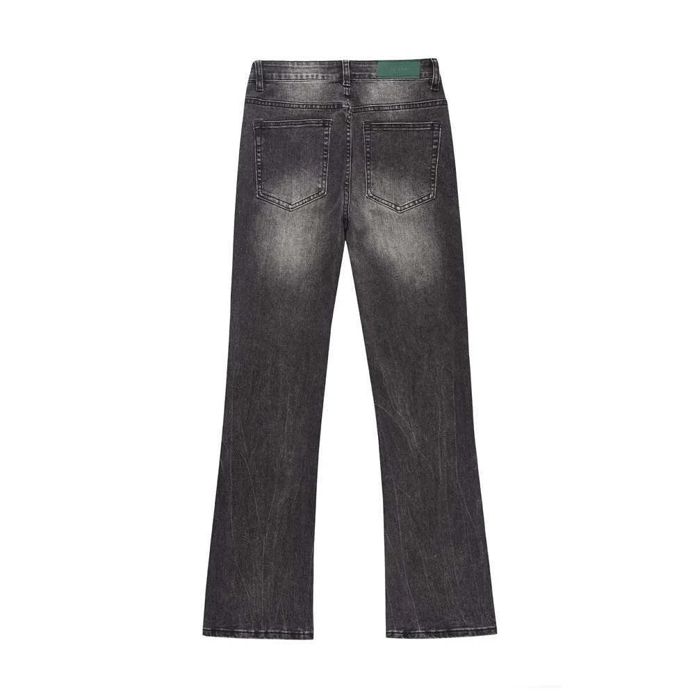 Men's black washed denim jeans on a flat surface showing full leg and pocket details
