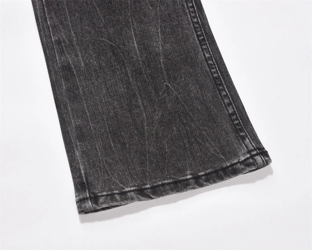 Men's black washed denim jeans on a flat surface showing full leg and pocket details