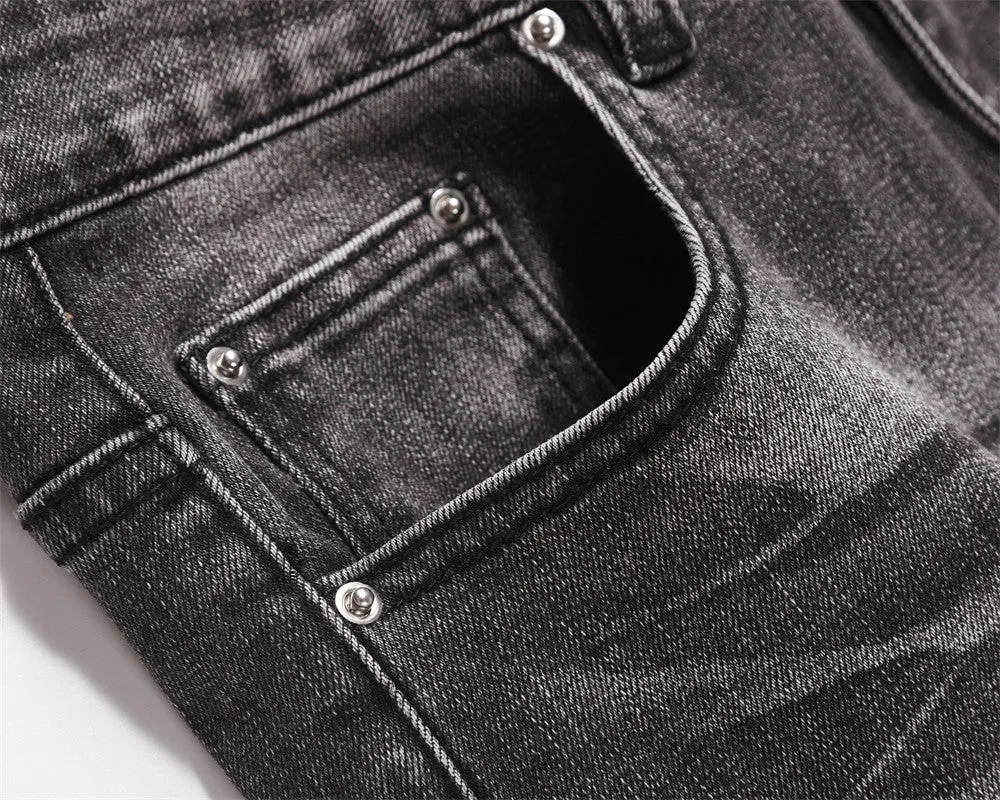 Men's black washed denim jeans on a flat surface showing full leg and pocket details