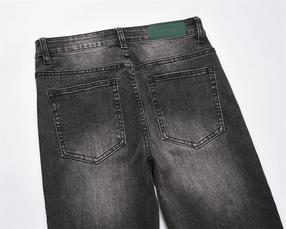 Men's black washed denim jeans on a flat surface showing full leg and pocket details
