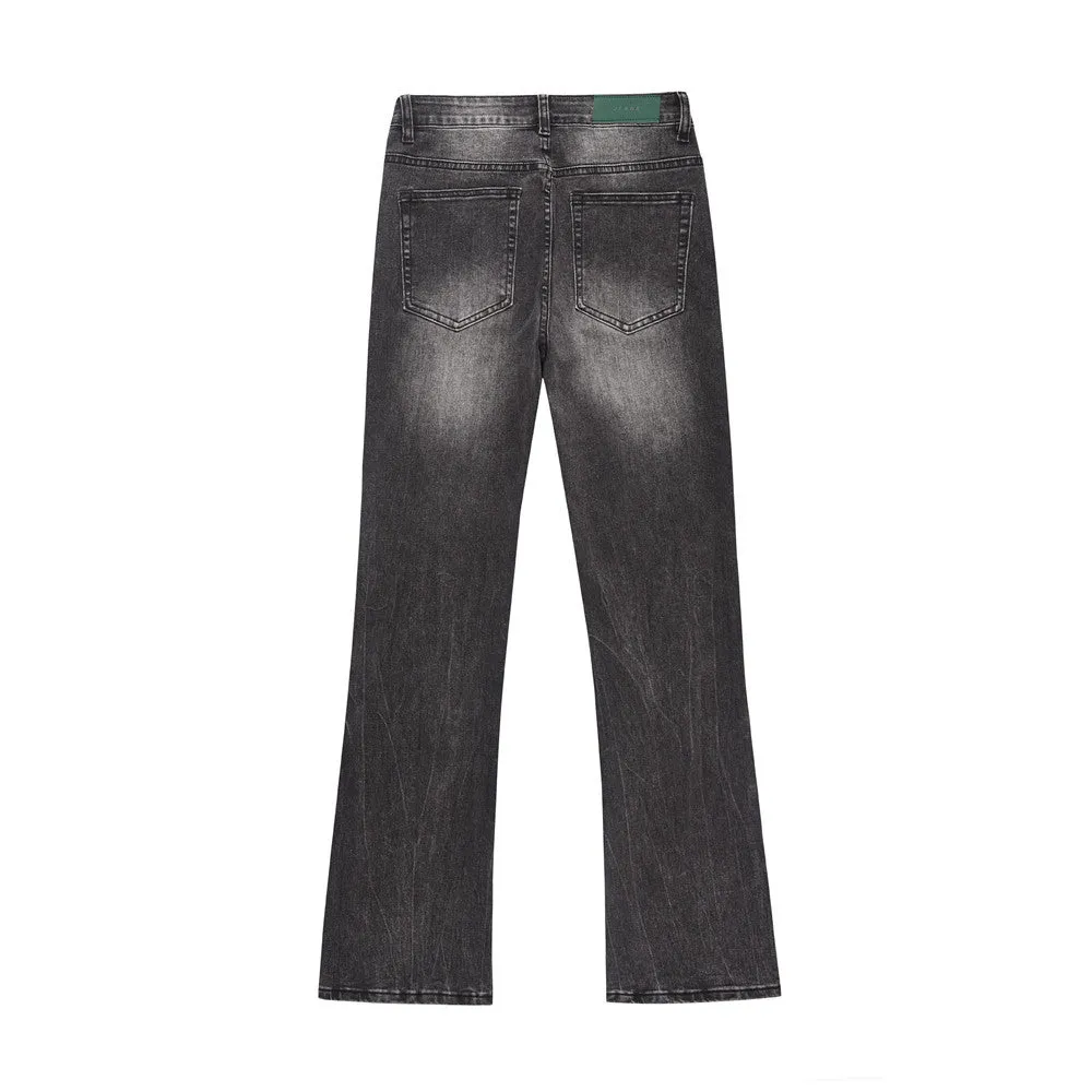 Men's black washed denim jeans on a flat surface showing full leg and pocket details
