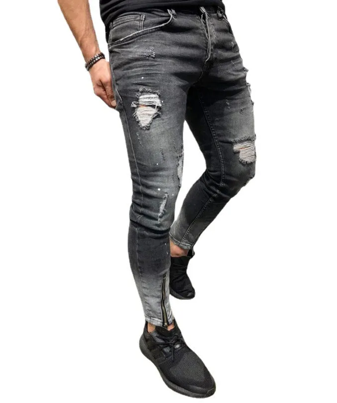 Men's black ripped denim jeans with zipper and elasticated ankle cuffs, shown flat on surface.