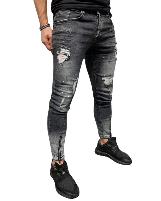 Men's black ripped denim jeans with zipper and elasticated ankle cuffs, shown flat on surface.