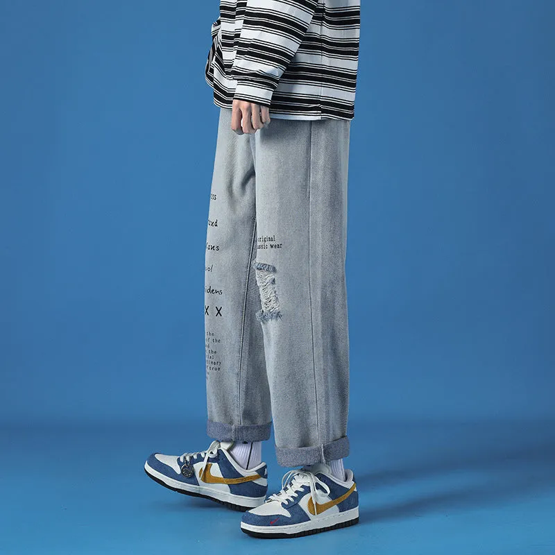 Men's loose fit washed cotton jeans in light blue with printed design and zipper fly, available in sizes M to 5XL