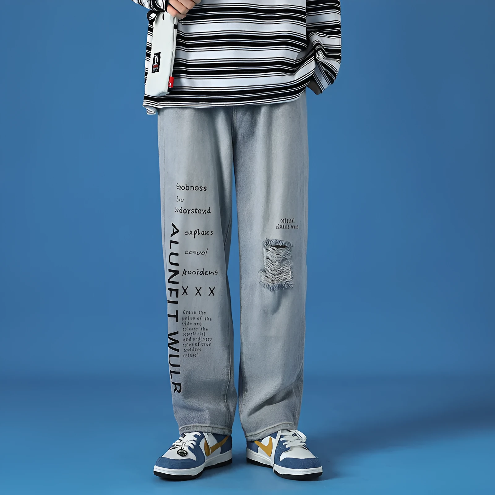 Men's loose fit washed cotton jeans in light blue with printed design and zipper fly, available in sizes M to 5XL