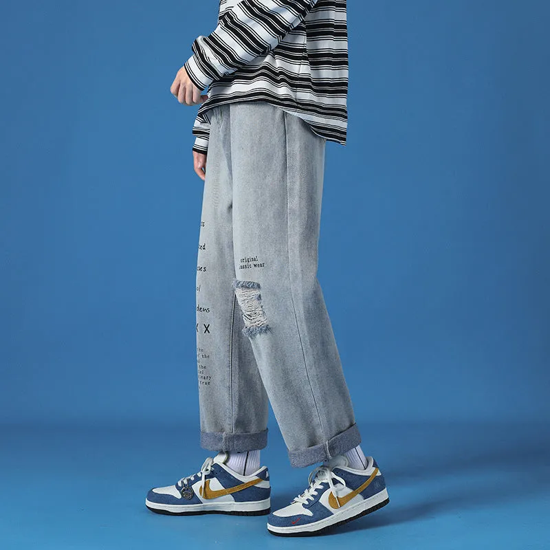 Men's loose fit washed cotton jeans in light blue with printed design and zipper fly, available in sizes M to 5XL