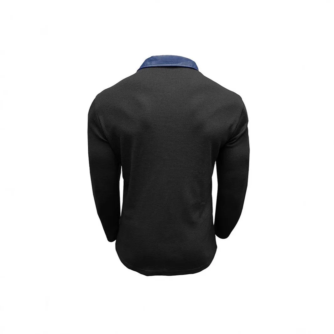Man wearing a dark grey long-sleeved waffle-texture polo shirt with an asymmetric design detail.