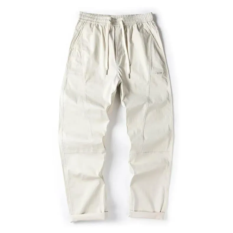 Beige cotton wide-leg casual trousers with elasticated waistband displayed flat