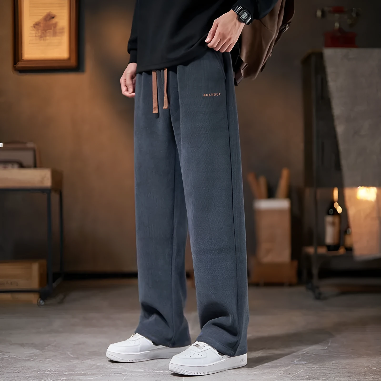 Men's loose straight-leg fleece-lined trousers in dark gray, polyester fabric, mid-rise waist, side view