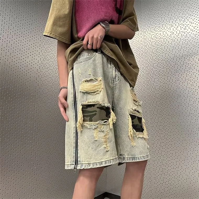 Men's yellow mud camouflage ripped denim shorts in a straight-leg style