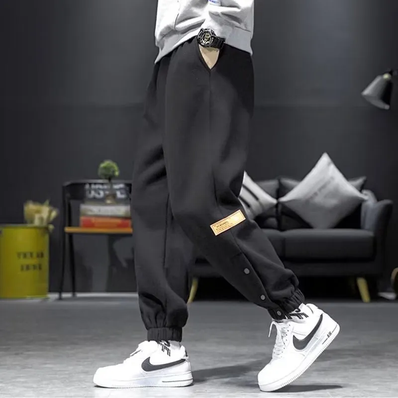 Velvet padded casual trousers for women in regular black with ankle strap and skinny leg style