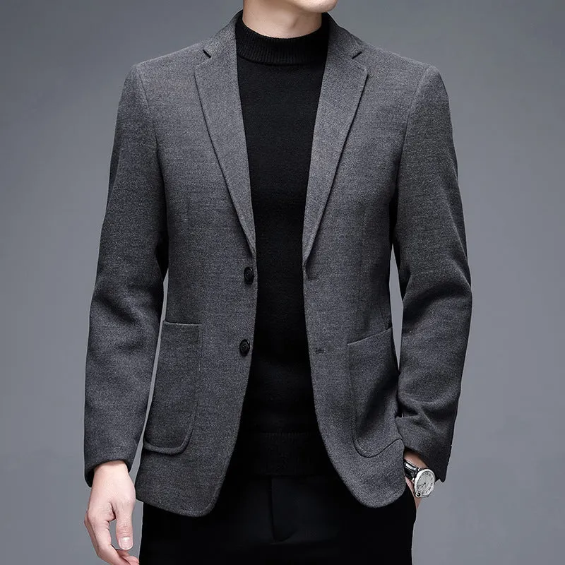 Men's solid colour woolen suit jacket with loose fit and round hem in winter setting.