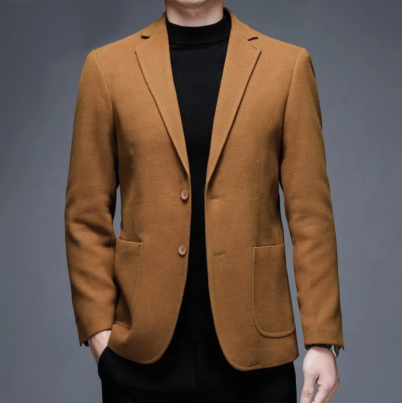 Men's solid colour woolen suit jacket with loose fit and round hem in winter setting.