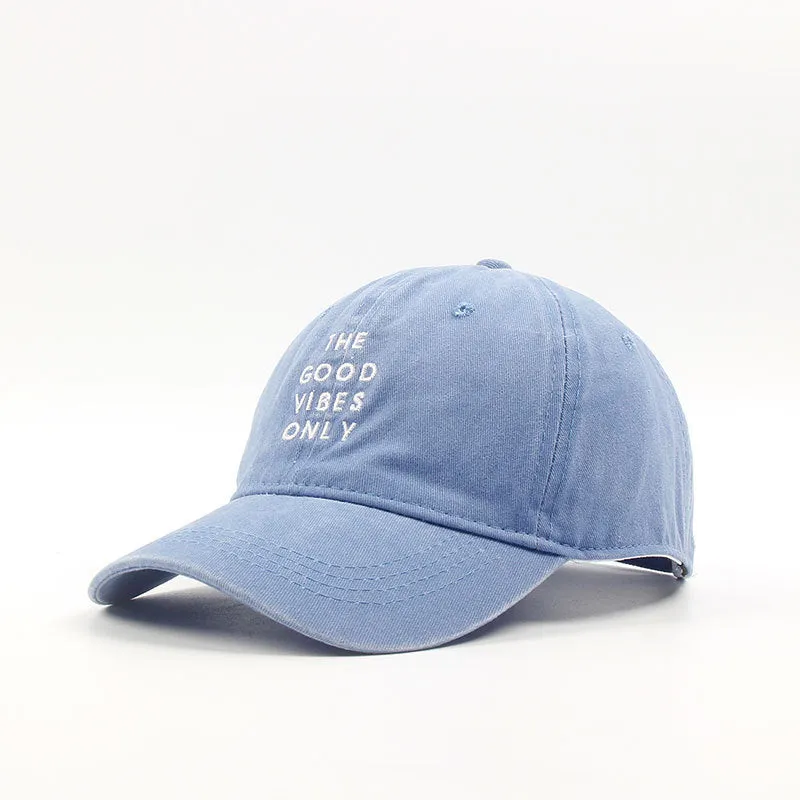 Washed cotton dad hat in bone colour with embroidered THE GOOD VIBES ONLY lettering, adjustable snapback, short curling brim