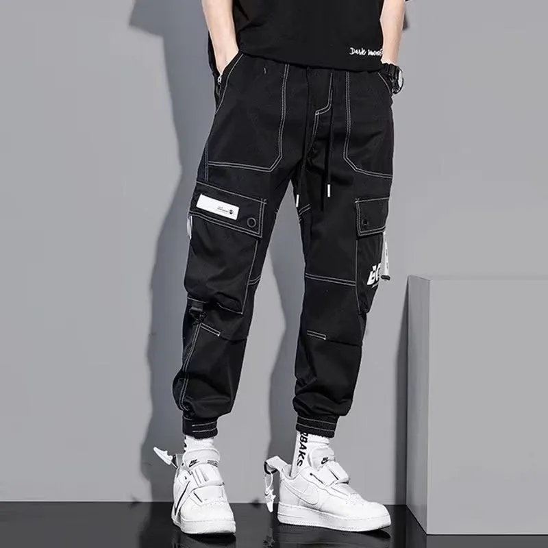 Men's loose fit solid colour polyester trousers in gray, front view, for casual autumn wear