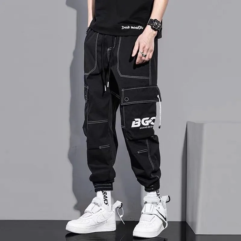 Men's loose fit solid colour polyester trousers in gray, front view, for casual autumn wear