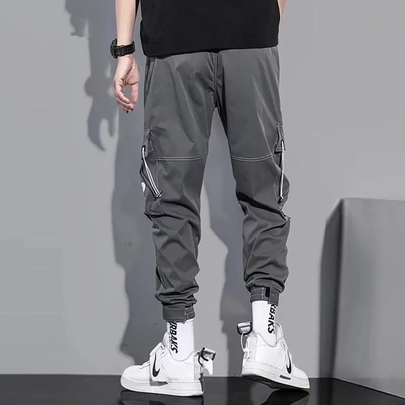 Men's loose fit solid colour polyester trousers in gray, front view, for casual autumn wear
