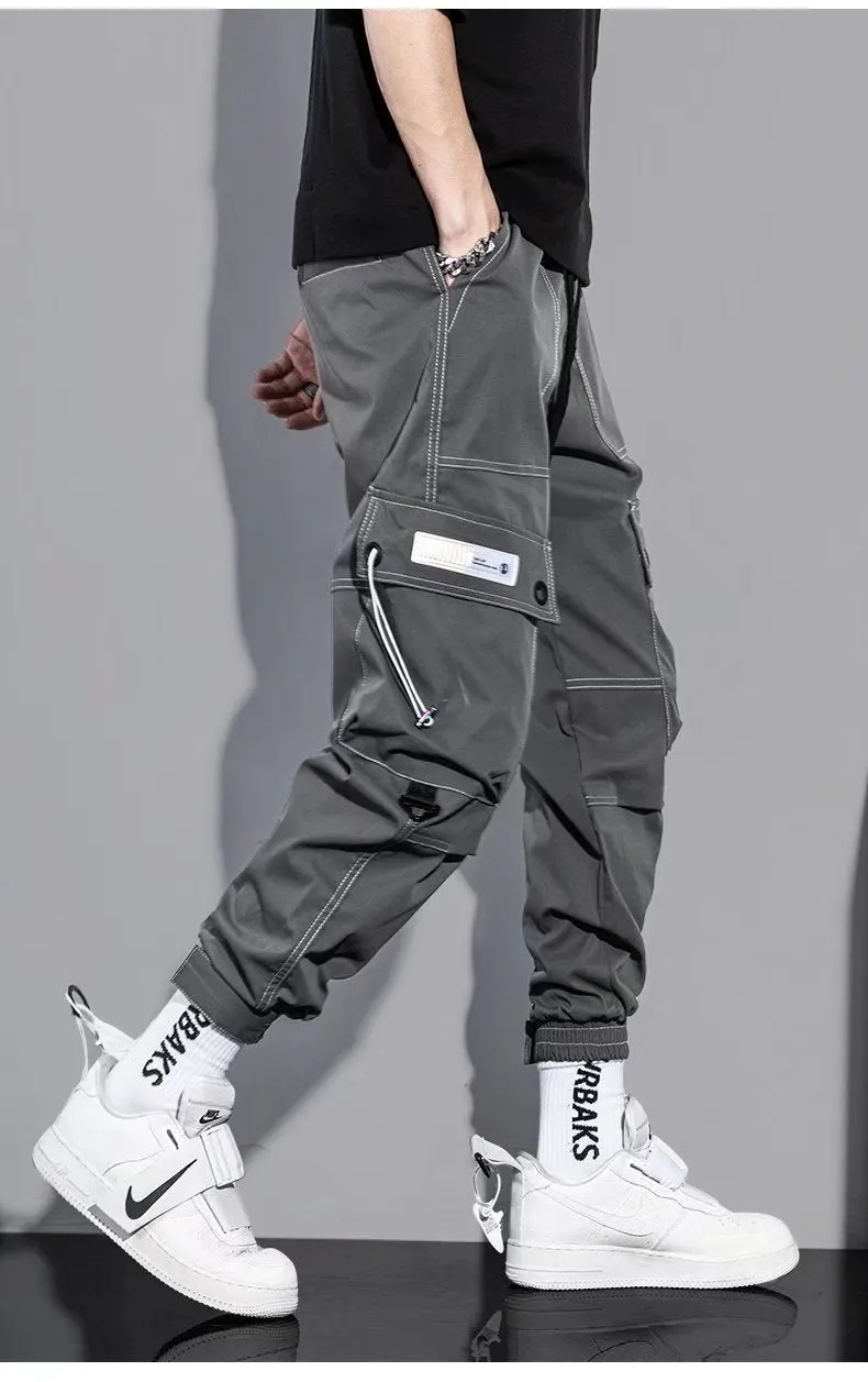 Men's loose fit solid colour polyester trousers in gray, front view, for casual autumn wear
