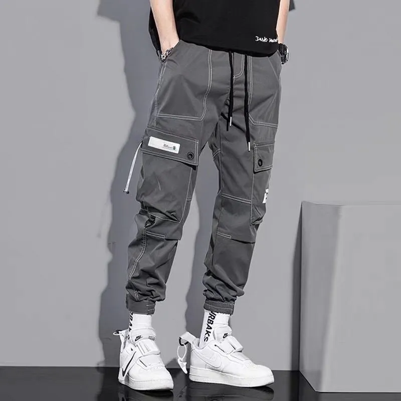 Men's loose fit solid colour polyester trousers in gray, front view, for casual autumn wear