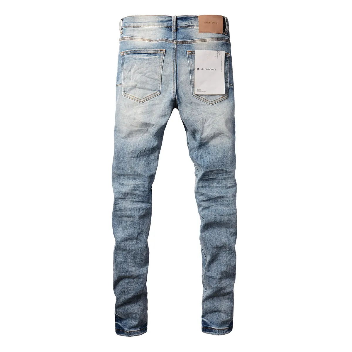 Men's blue denim pencil leg jeans with low waist and zipper fly on a person standing
