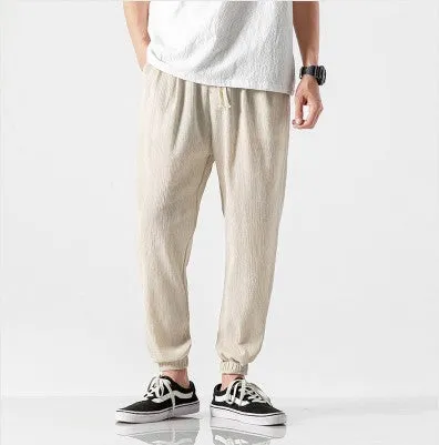 Men's cotton linen harem trousers in beige, shown with elastic waistband and tapered legs, available in multiple sizes and colours