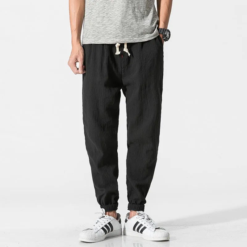 Men's cotton linen harem trousers in beige, shown with elastic waistband and tapered legs, available in multiple sizes and colours