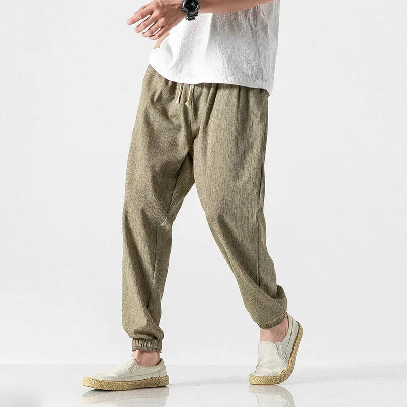 Men's cotton linen harem trousers in beige, shown with elastic waistband and tapered legs, available in multiple sizes and colours
