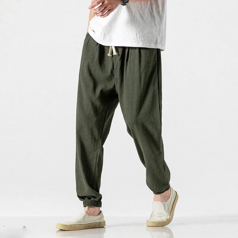 Men's cotton linen harem trousers in beige, shown with elastic waistband and tapered legs, available in multiple sizes and colours