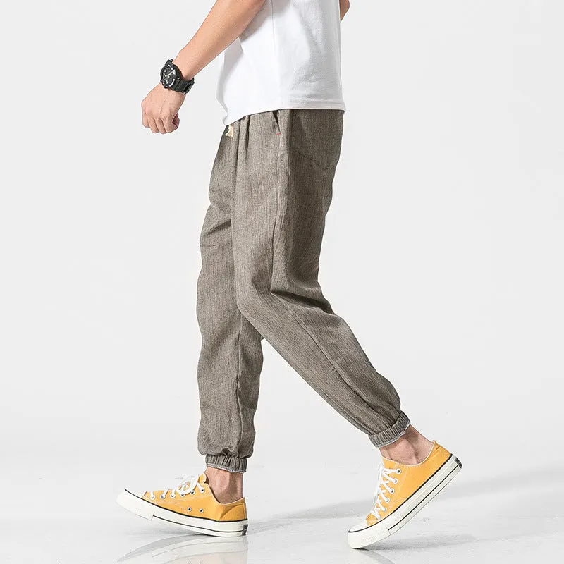 Men's cotton linen harem trousers in beige, shown with elastic waistband and tapered legs, available in multiple sizes and colours