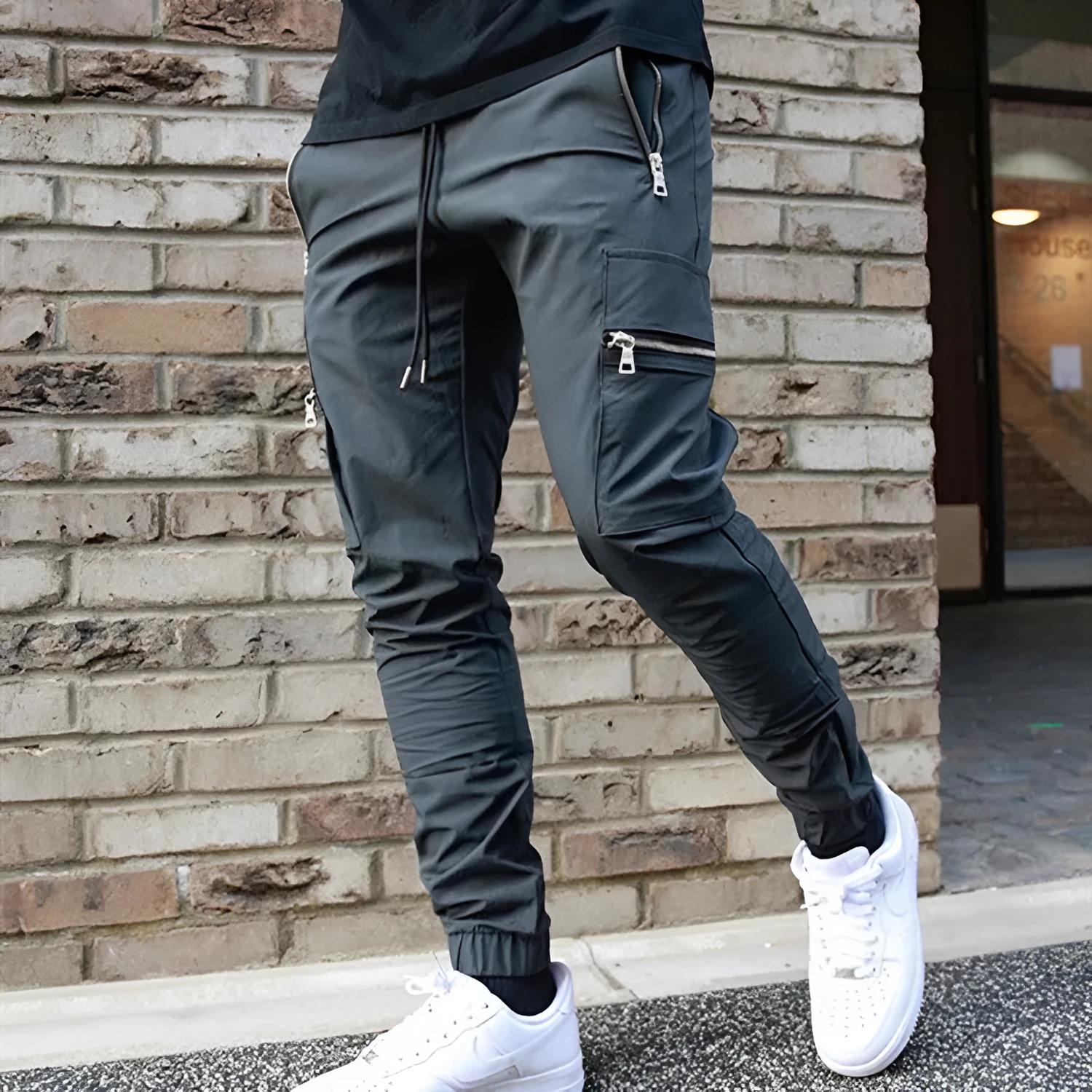 Men's zipper multi-pocket loose fit trousers in black, 95% polyester chemical fiber blend, with belt and small leg opening