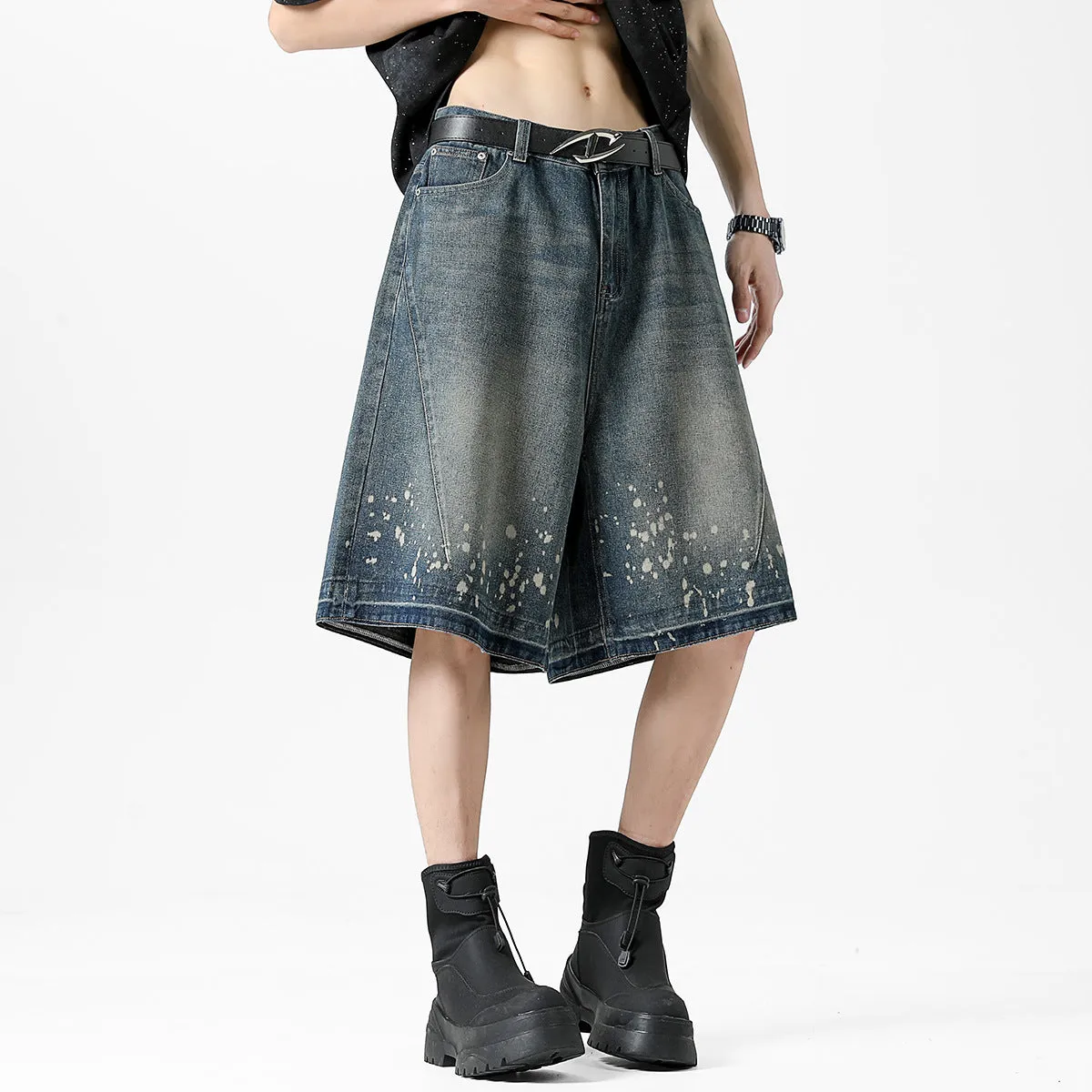 Retro blue washed denim shorts for men with a splash ink pattern and ripped detailing on the legs.
