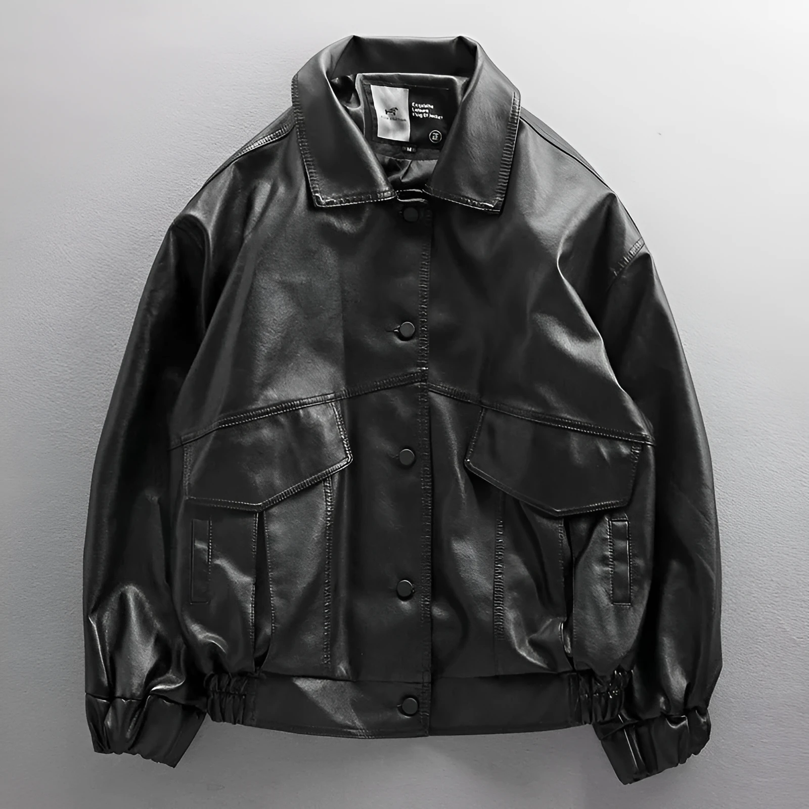 Men's black PU leather biker jacket loose street style with padded design on a model