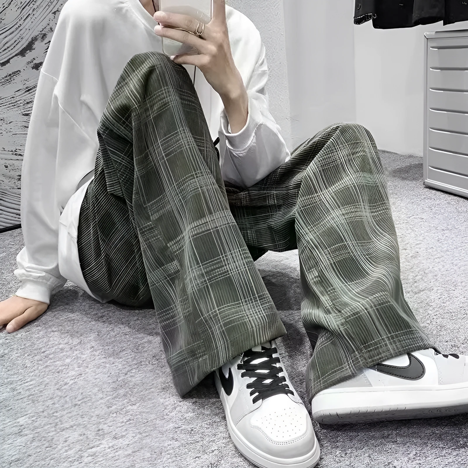 Men's black and green plaid trousers with straight leg design and mid-rise waistband