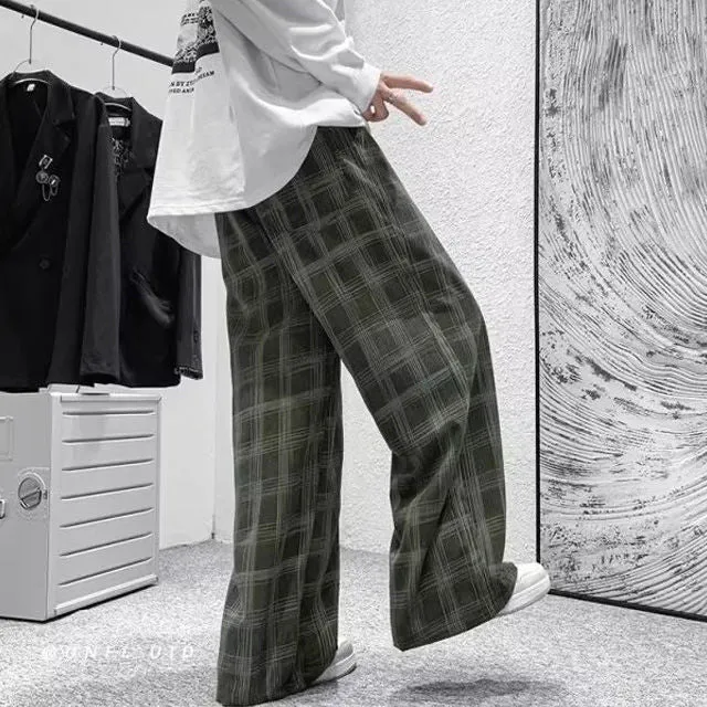 Men's black and green plaid trousers with straight leg design and mid-rise waistband