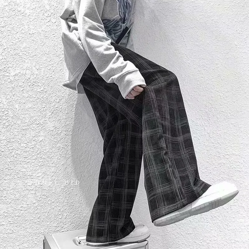 Men's black and green plaid trousers with straight leg design and mid-rise waistband