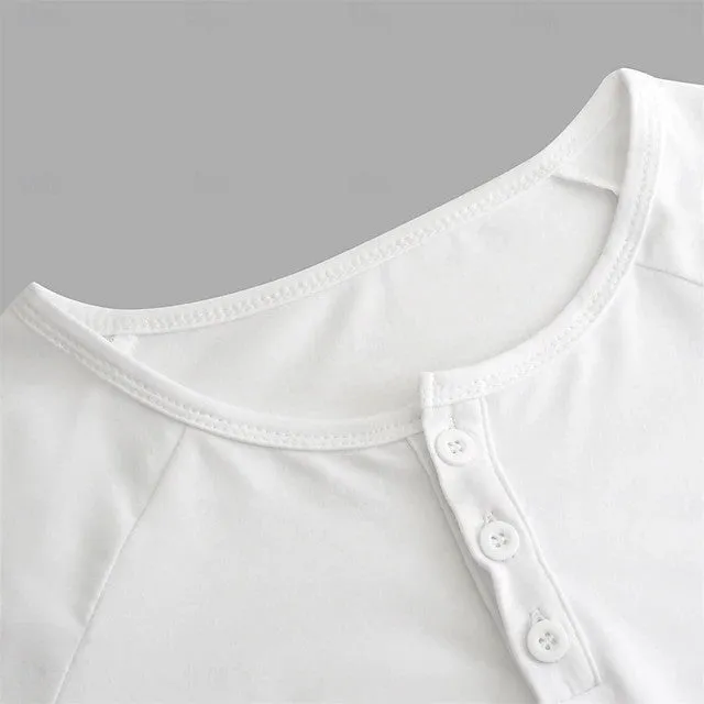 Man wearing a navy blue long-sleeved T-shirt with a Henry collar, made from cotton blend fabric.