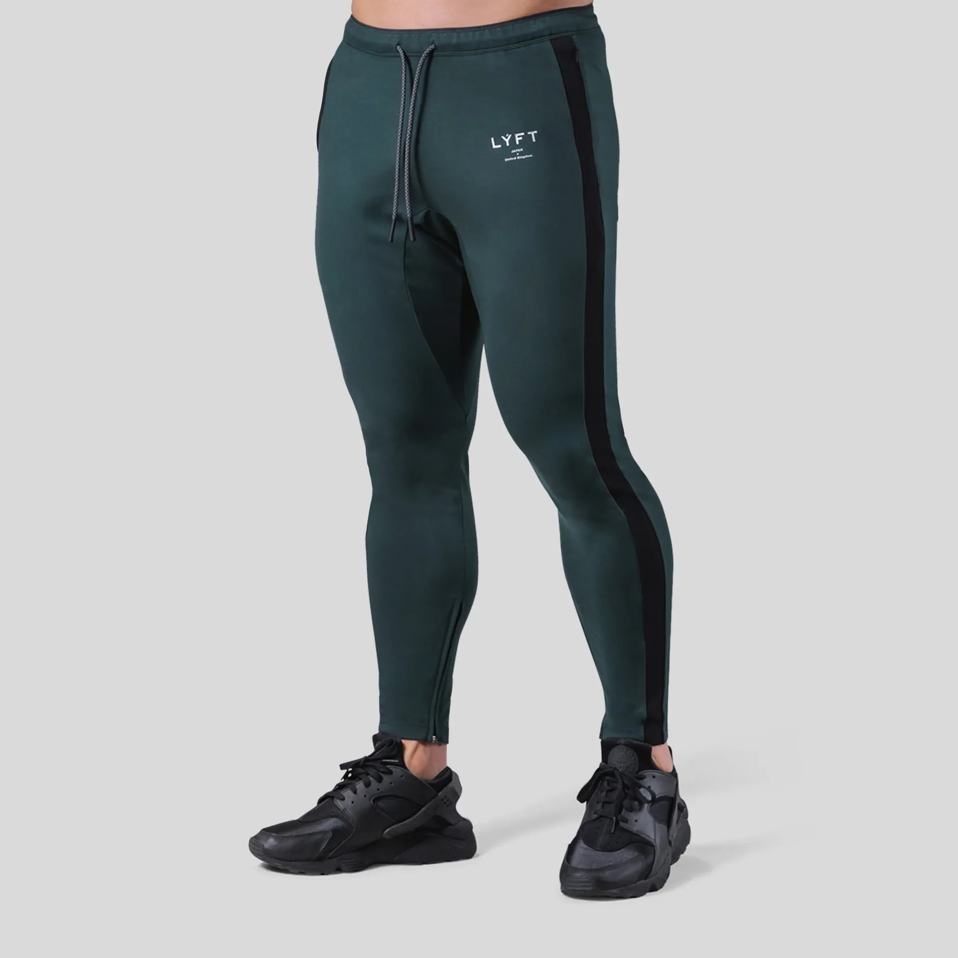 Men's polyester fitness training pants in green, black, navy blue and grey colours for gym workout and bodybuilding